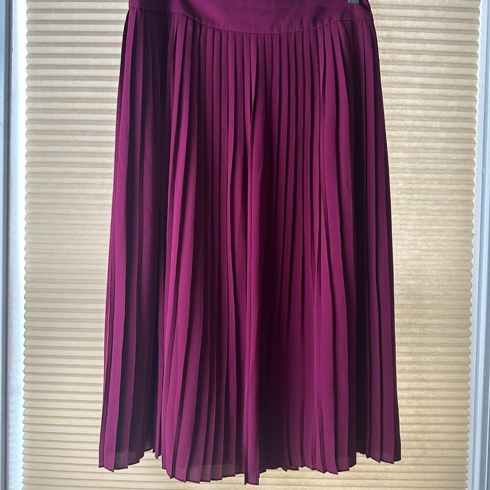 Pink, mid-length, pleated skirt.